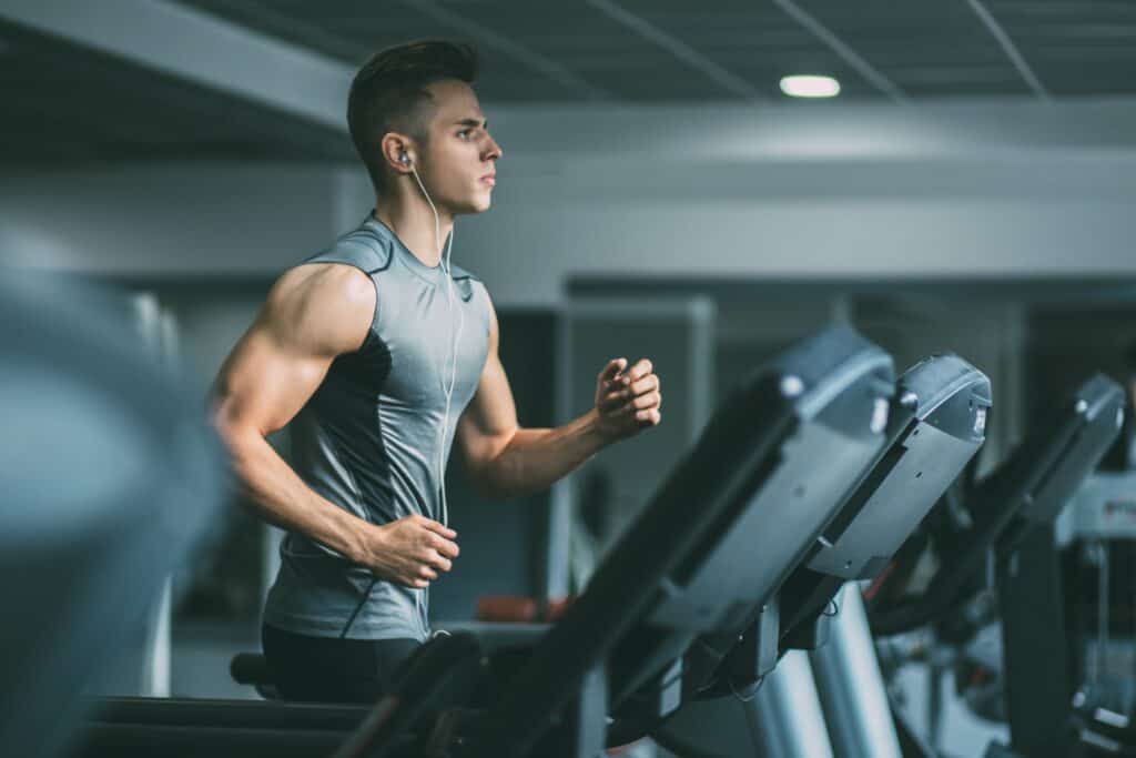 Man running on a treadmill in the gym.
